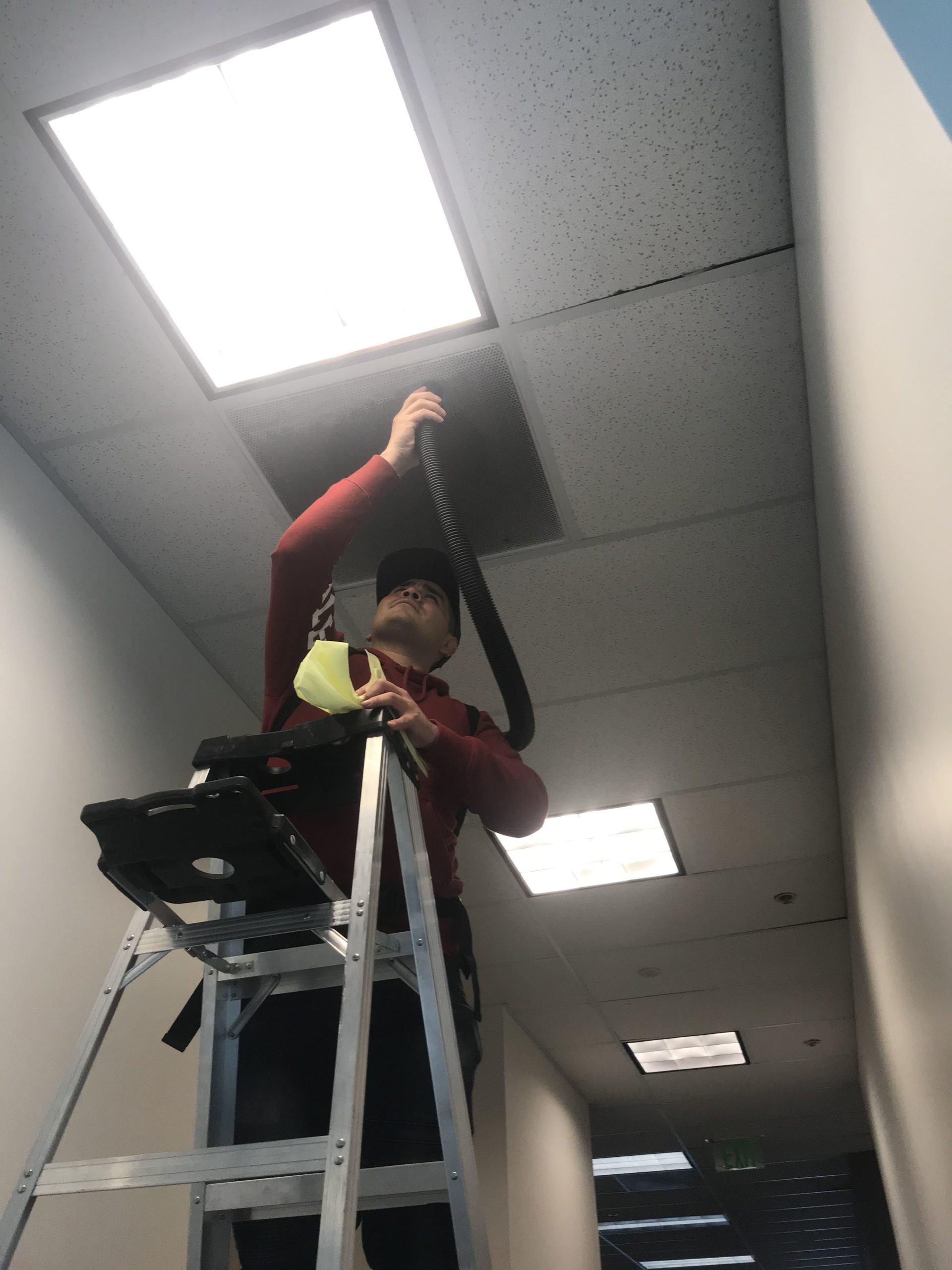Man cleaning air vents